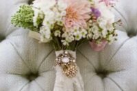 a lace wrap with a rhinestone brooch is an amazing accent for a vintage-inspired wedding bouquet