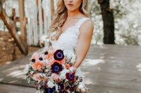 a lovely and catchy cascading wedding bouquet with white, orange, burgundy blooms and some cascading ones plus greenery for a boho bride