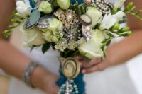 a neutral wedding bouquet of roses and tulips, greenery and vintage brooches is a cool and bold idea for a wedding