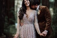 a silver sequin wedding dress with a deep neckline, long sleeves and a pleated skirt is a catchy and chic solution