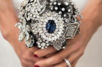a small vintage brooch wedding bouquet in silver and navy is a fantastic and super chic idea for a vintage bride