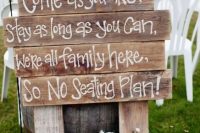 a stained wooden sign, white blooms in buckets are gerat to decorate a rustic wedding
