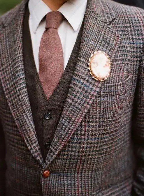 a vintage brooch instead of a boutonniere looks elegant and sticks to the vintage inspired style of the groom