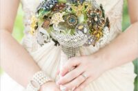 a vintage brooch wedding bouquet of bold brooches, pearls, rhinestones and feathers is a lovely accessory for a non-traditional bride