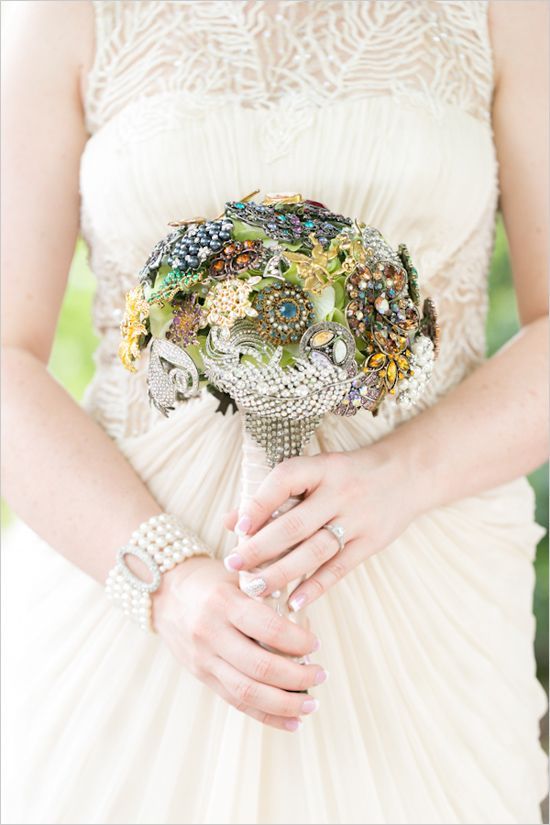 a vintage brooch wedding bouquet of bold brooches, pearls, rhinestones and feathers is a lovely accessory for a non traditional bride