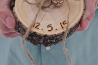 an alternative ring dish for a rustic wedding, with monograms and a date, with wedding rings with twine