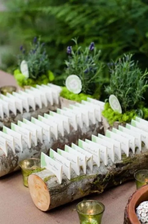 real wood logs as wedding place card holders for a woodland or just nature infused wedding, they can be also used for rustic weddings