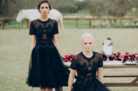two brides wearing matching chic and sparkling black wedding dresses of different lengths