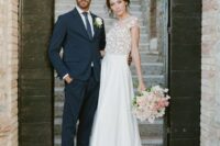 a beautiful A-line wedding dress with a floral applique bodice with cap sleeves and a plain skirt