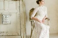 a beautiful lace semi-ftting vintage wedding dress with a high neckline, short sleeves, a train is a very chic and beautiful idea