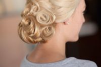 a catchy pin curl vintage low updo looks lovely and bold and catches the vintage feel