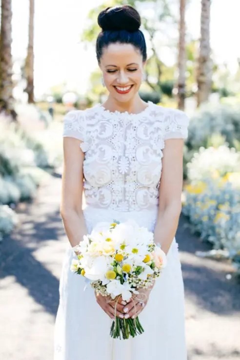 a chic modern wedding dress with a lace applique bodice, a high neckline and short sleeves plus a plain skirt is wow