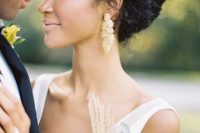 a chic wedding updo of more or less straight hair but with plenty of texture and a bump on top