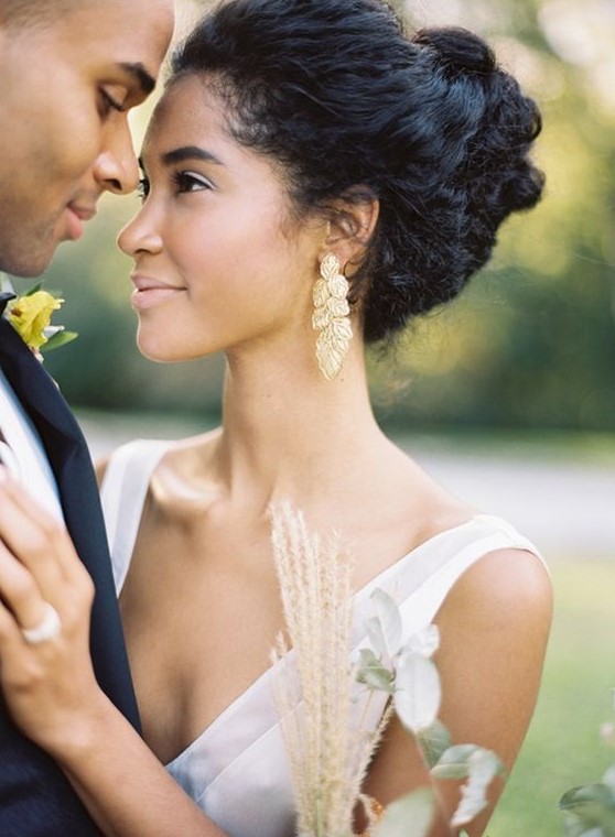 a chic wedding updo of more or less straight hair but with plenty of texture and a bump on top