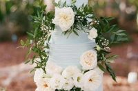a classic textural powder blue wedding cake decorated with neutral blooms, greenery and leaves is ideal for a vintage wedding in spring or summer