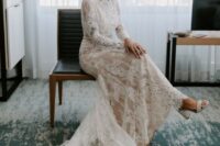 a creamy lace wedding dress with long sleeves, a high neckline, a trian and white block heels is ideal for a traditional wedding ceremony