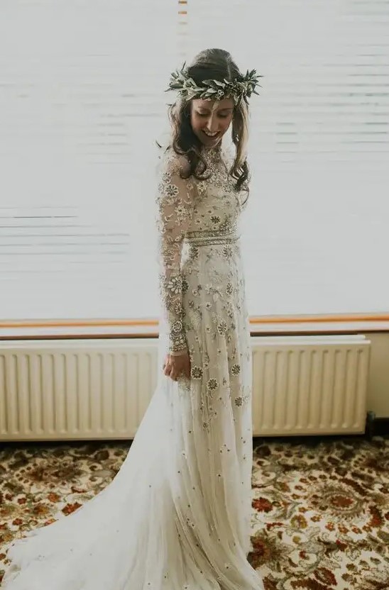 a delicate boho wedding dress with neutral and silver floral embroidery, long sleeves and embellishments looks chic