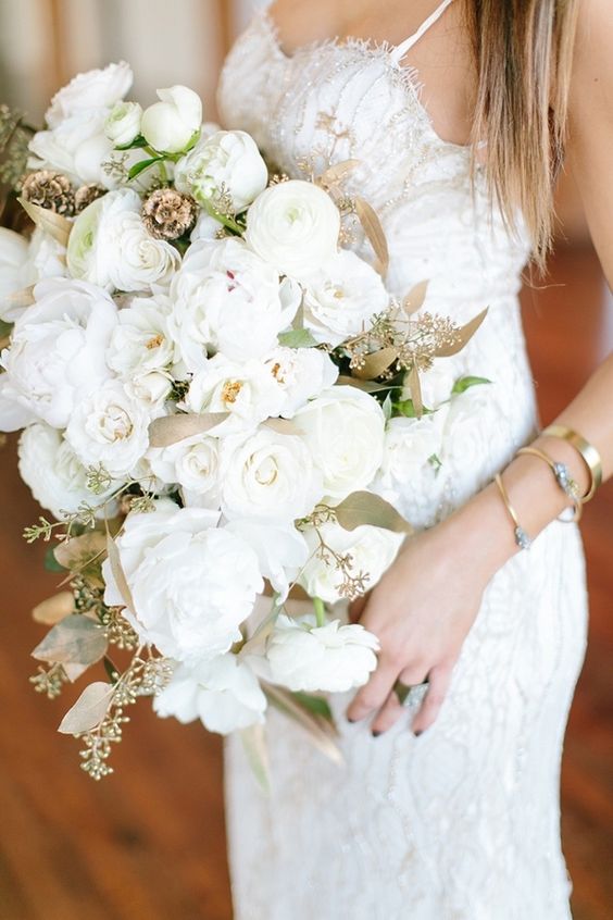a fabulous wedding bouquet of white blooms and gilded leaves is a gorgeous idea for a glam bride