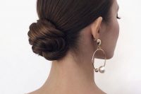 a formal wedding updo with a twisted low bun and a sleek top is a chic and beautiful idea that will fit any formal wedding