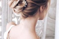 a lovely hairstyle with a pearl hairpiece
