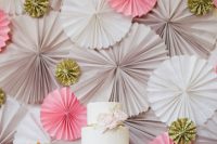 a grey, wihte and pink plus gold glitter paper fan wedding backdrop is a nice idea for a wedidng dessert table