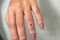 a heart-shaped tattoo with dots on the ring finger is a lovely and very romantic idea for your wedding day
