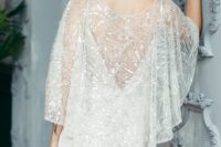 a jaw-dropping embellished bridal capelet will easily cover up your wedding dress adding chic and a bold touch to the look