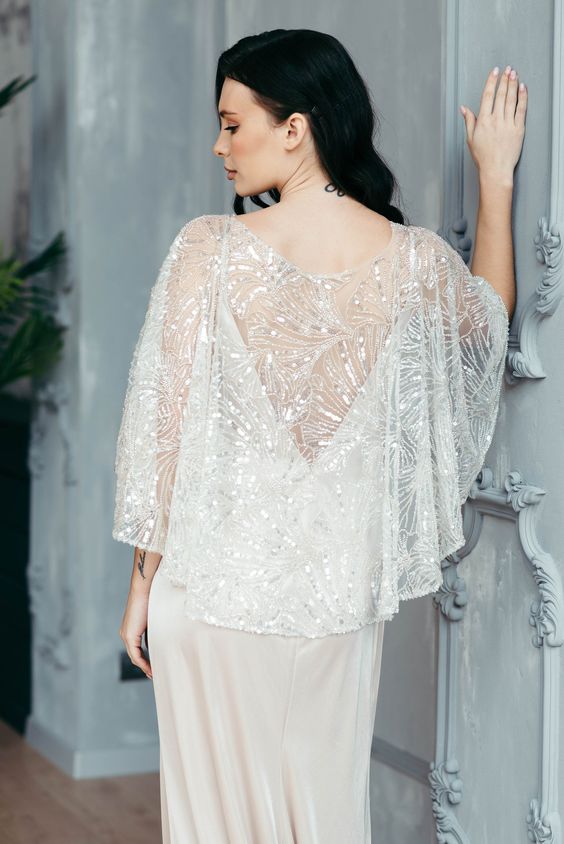 a jaw-dropping embellished bridal capelet will easily cover up your wedding dress adding chic and a bold touch to the look
