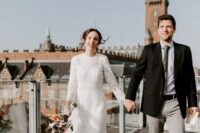 a lace A-line midi wedding dress with a high neckline and long sleeves plus white shoes for a city elopement