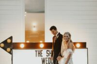 a large sign accented with a marquee arrow is a cool idea for a more relaxed wedding, you can DIY one yourself