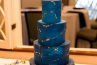 a navy and midnight blue wedding cake with gold stars inspired by the Starry Night by Van Gogh is amazing for a wedding