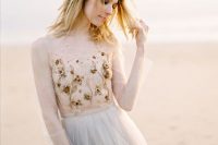 a nude bodice with gold, copper beads and pearls that show off flowers looks beautiful and refined