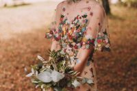 a nude wedding dress with colorful floral crochet appliques will create an unforgettable and bold look