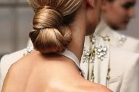 a perfect sleek knotted low bun is eye-catchy yet very simple and is ideal for a minimalist bride