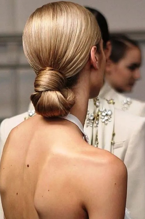 a perfect sleek knotted low bun is eye-catchy yet very simple and is ideal for a minimalist bride