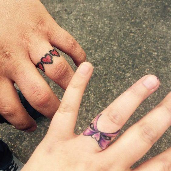 a pixel heart ring and a bow ring on the ring finger are a lovely tattoo idea for couples, make them on your wedding day