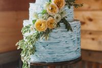a ruffle powder blue wedding cake decorated with greenery and neutral and rust blooms is a lovely idea for a rustic wedding