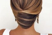 a sleek and tight wedding updo with a twist and some volume on top is a gorgeous idea for a sophisticated bride