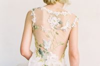 a stunning sheath wedding dress with gorgeous floral and butterfly appliques on the sheer back and green embroidery