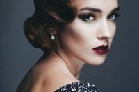 a super chic wavy low updo with color accents and a matching makeup for a modern yet vintage-inspired bride
