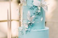 a tiffany blue wedding cake with matching sugar blooms, dried blooms and twigs is a very chic and beautiful spring or summer wedding idea