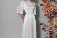 a vintage-inspired bridal look with a silk A-line wedding dress, wide bell sleeves, a high neckline, a train is a lovely idea to try, and silk guarantees timeless elegance