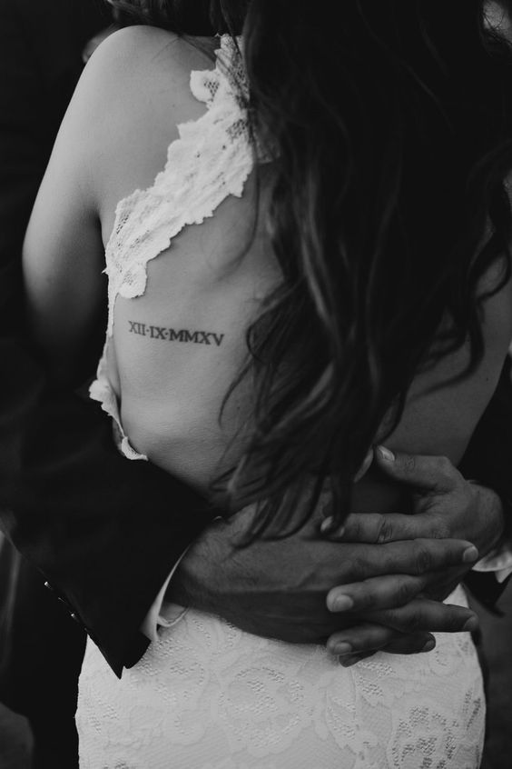a wedding date tattoo placed on the back where the wedding dress is cutout