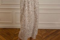 a white fluffy A-line midi skirt with some sequins looks very modern, glam and girlish