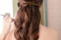 an elegant wedding half updo with a volume on top, some twists and waves down is a picture-perfect option