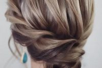 an exquisite low bun with a braided halo and a voluminous top plus locks down is very chic