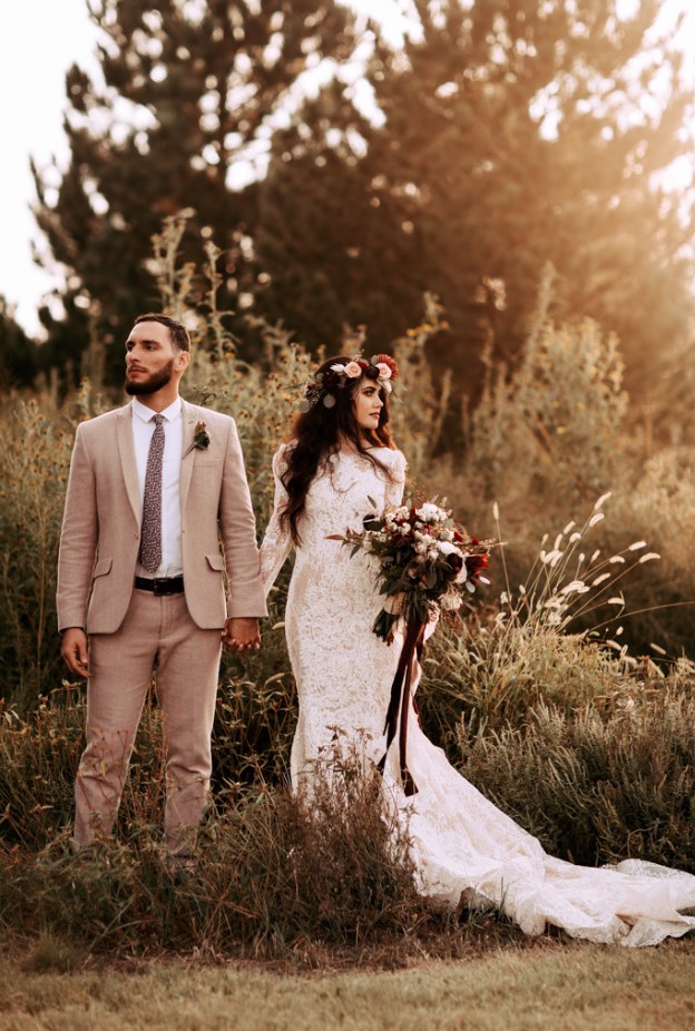 an ivory lace mermaid wedding dress with a train, a high neckline and long sleeves is a lovely idea for the fall