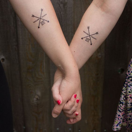 creative arrow and name tattoos on the forearms customized for the couple are cool and bold