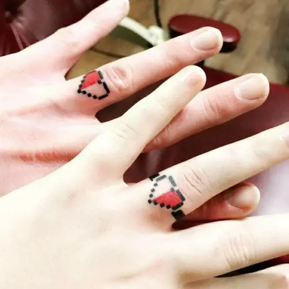 fun pixel heart wedding ring tattoos are bold and fun and will match many couples