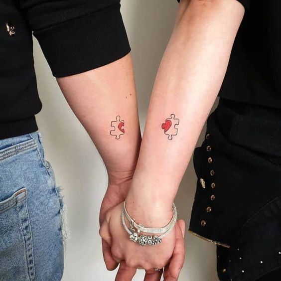 fun puzzle tattoos with a red heart are bold and creative, place them on forearms or wherever you want